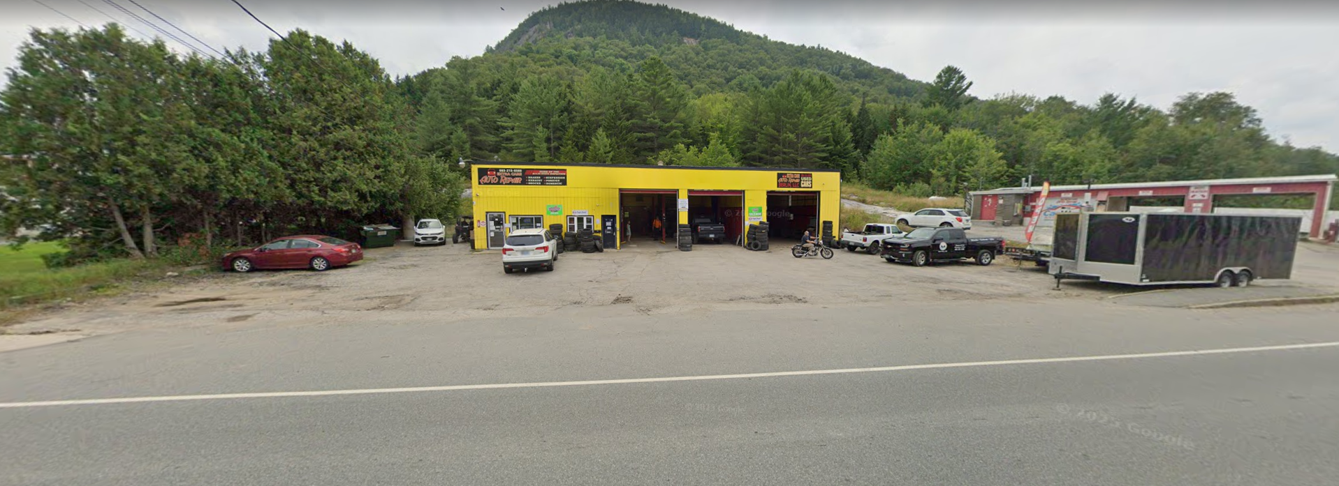 Roadside view of R&R Auto Repair on Wight Street, Berlin, NH with mountain backdrop